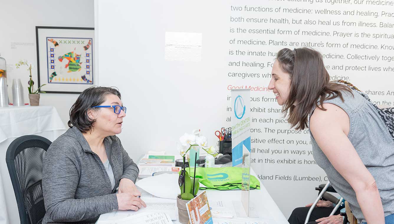 A social worker talks to a trainer from the Patient Navigation Training focused on integrative navigation